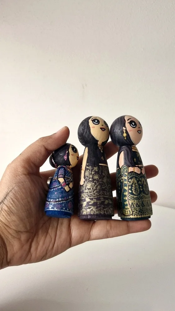 Every tiny textile pattern and jewellery detail is painted by hand with fine-tip brushes